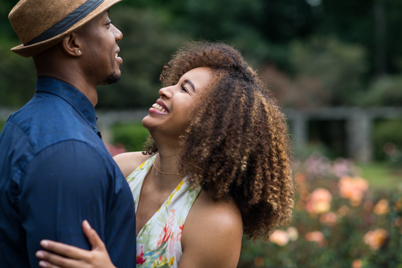woman laughs at partner in field of roses