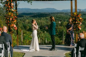 newlyweds exchange vows during ceremony at Longleaf Vineyard in Asheville NC