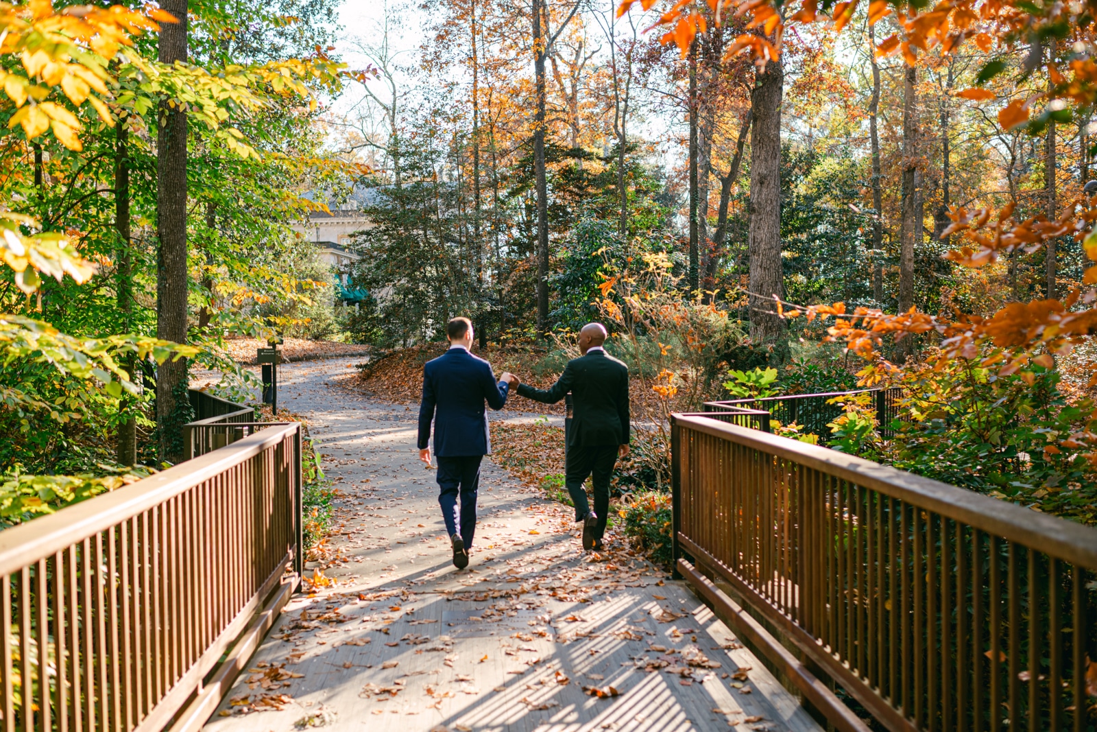 lgbtq+ couple holding hands walking to swan house for wedding photographed by atlanta wedding phootgrapher