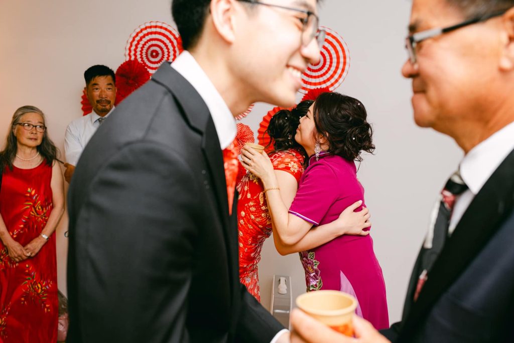 bride and groom hug parents during Chinese tea ceremony in Duluth GA home