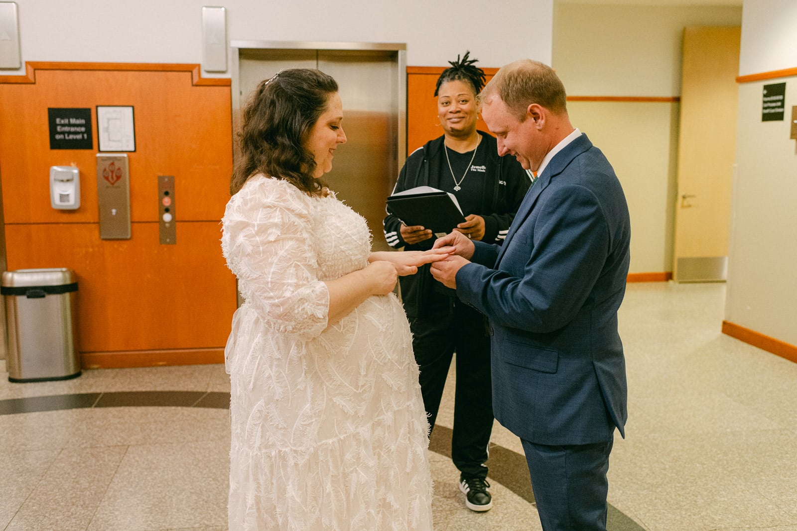 man and woman exchange vows in hallway of DeKalb historic courthouse
