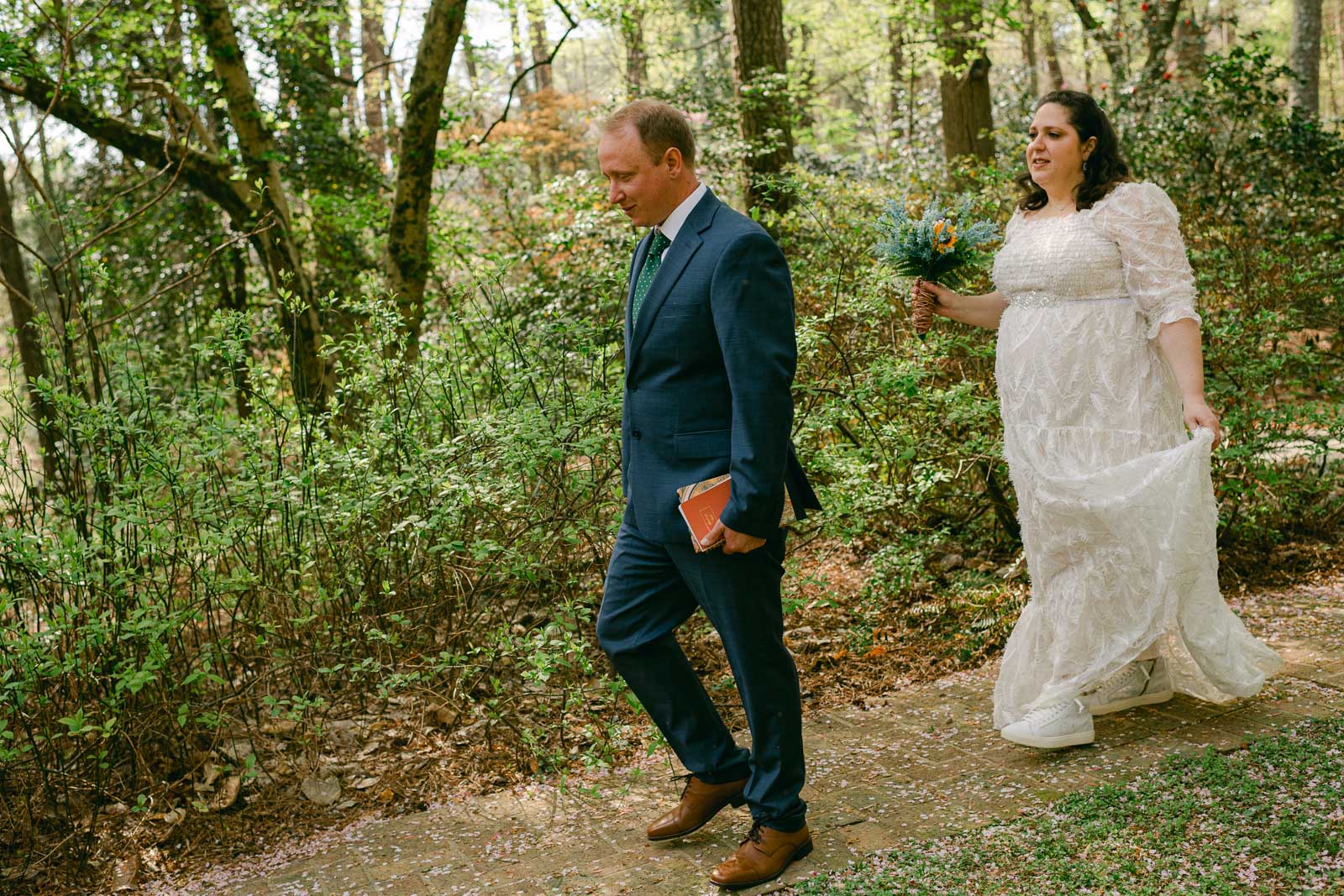 couple walks through Woodlands Garden on wedding day